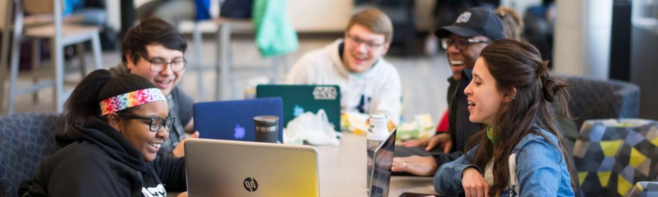 Students looking at a laptop in the Haas Performing Arts Center